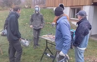 Group gathered around welding demonstration